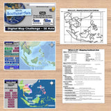 Educational materials on Southeast Asia including maps and text on a wooden surface